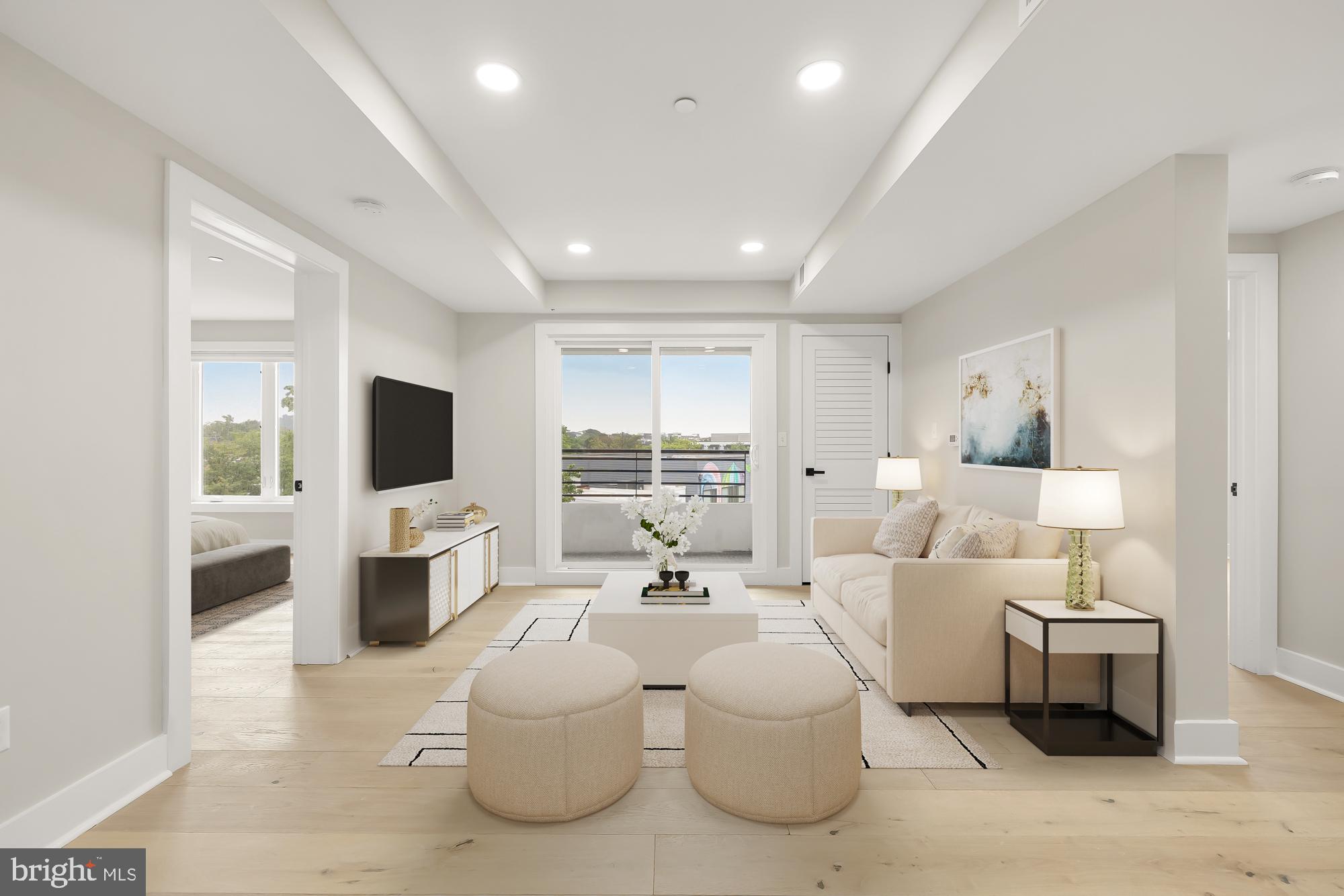 a living room with furniture a flat screen tv and a large window