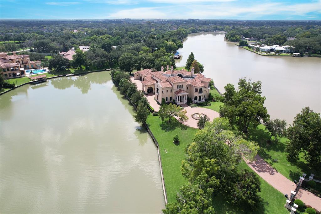 an aerial view of lake residential house with outdoor space and trees around