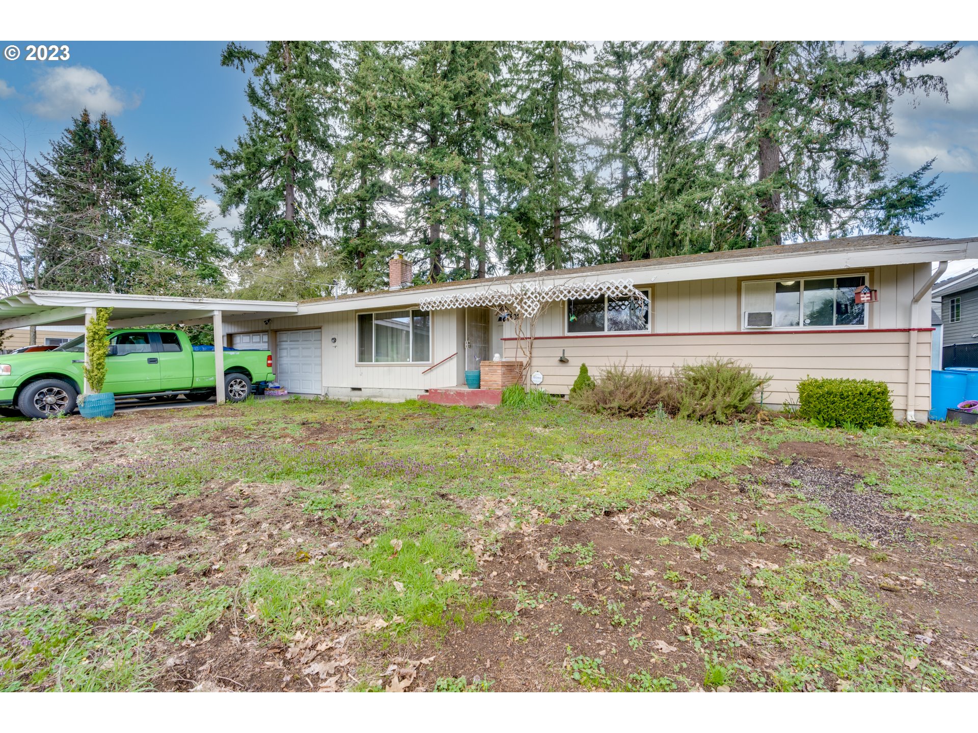 a view of house with yard and green space