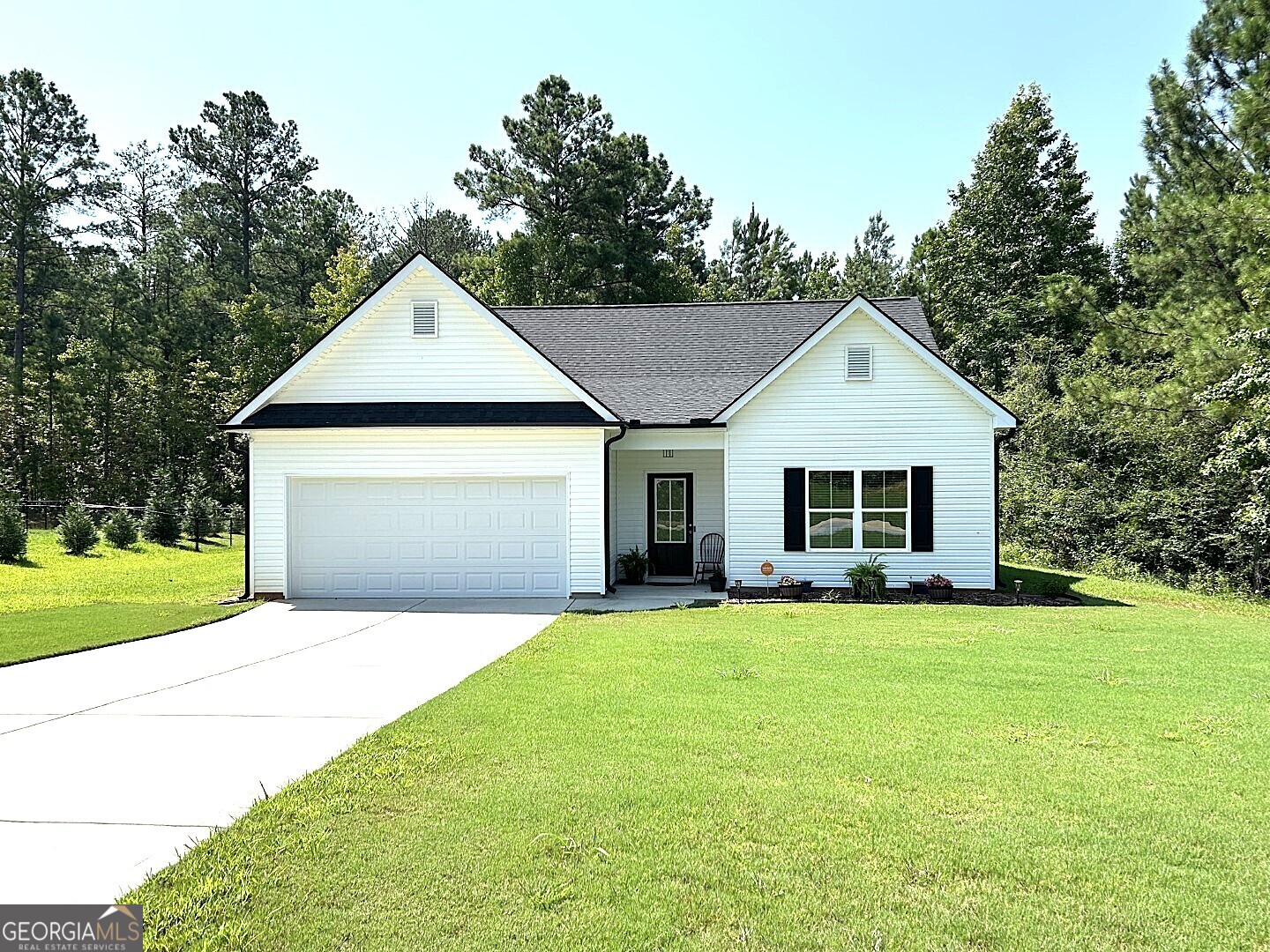 a front view of a house with yard and green space