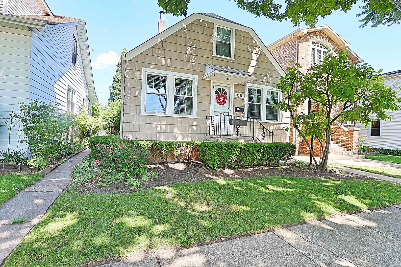 a front view of a house with a garden