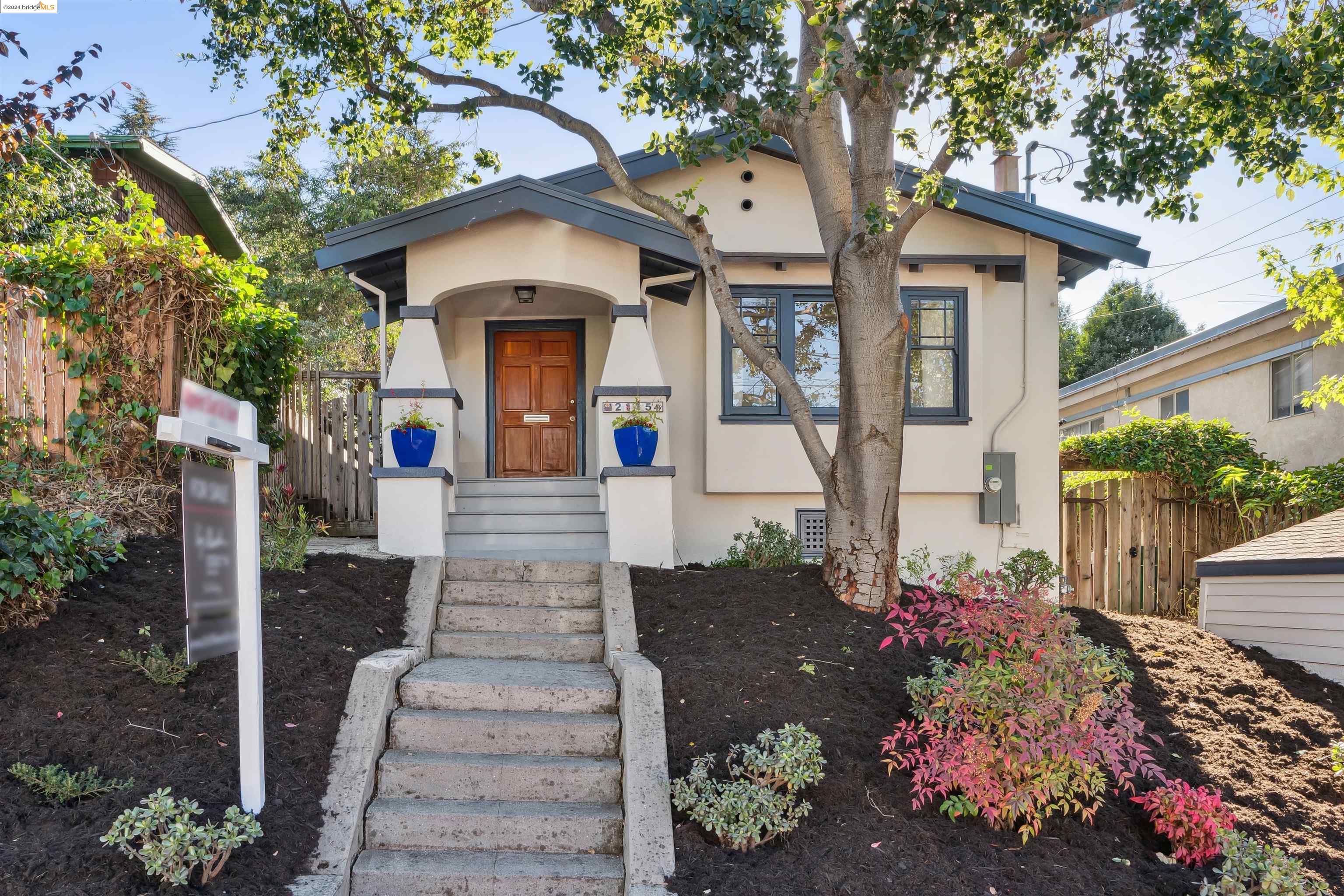 a front view of a house with a yard and fountain