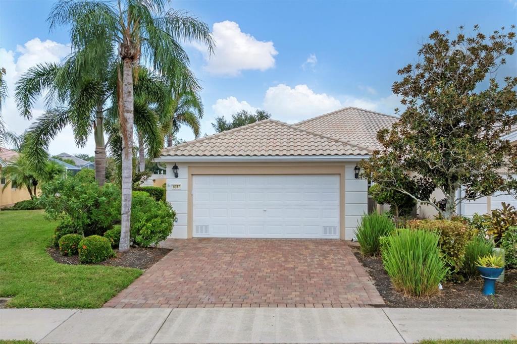 a front view of a house with a yard and garage