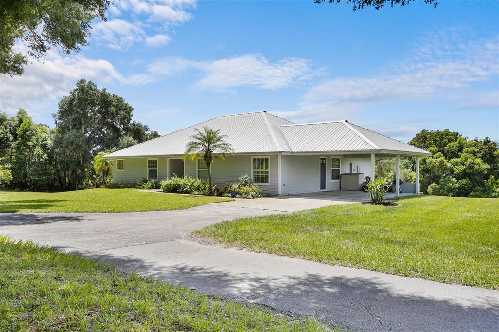 a front view of house with yard and green space