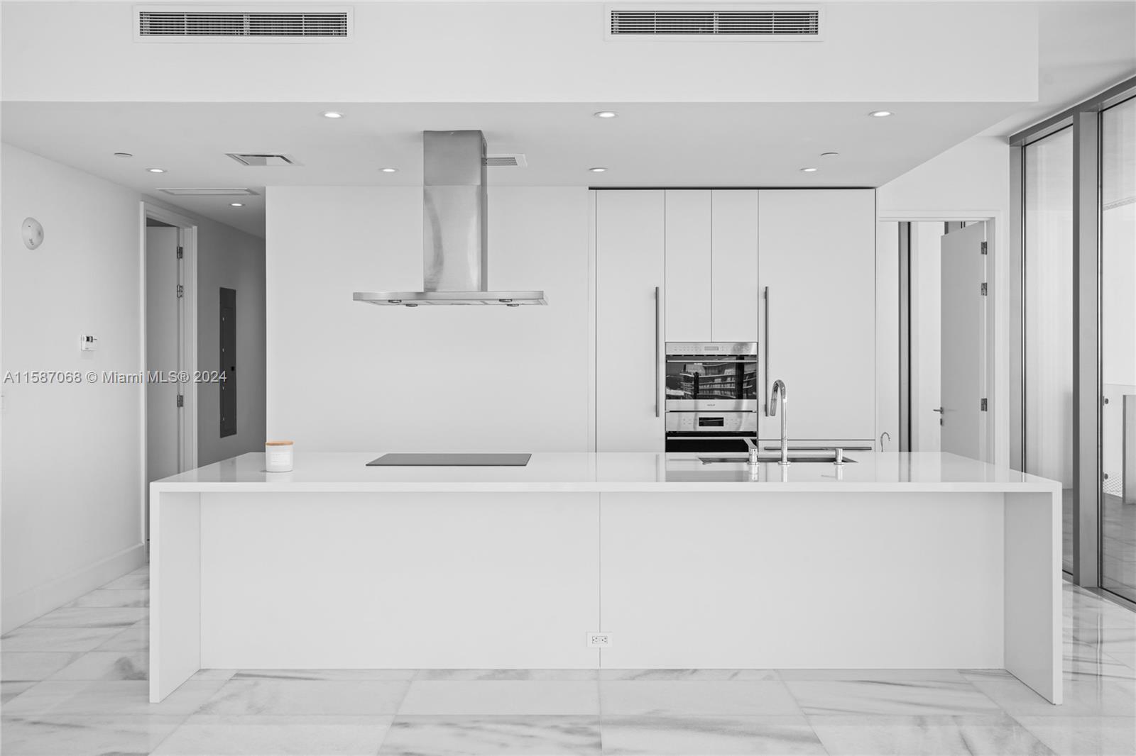 a white kitchen with cabinets and stainless steel appliances