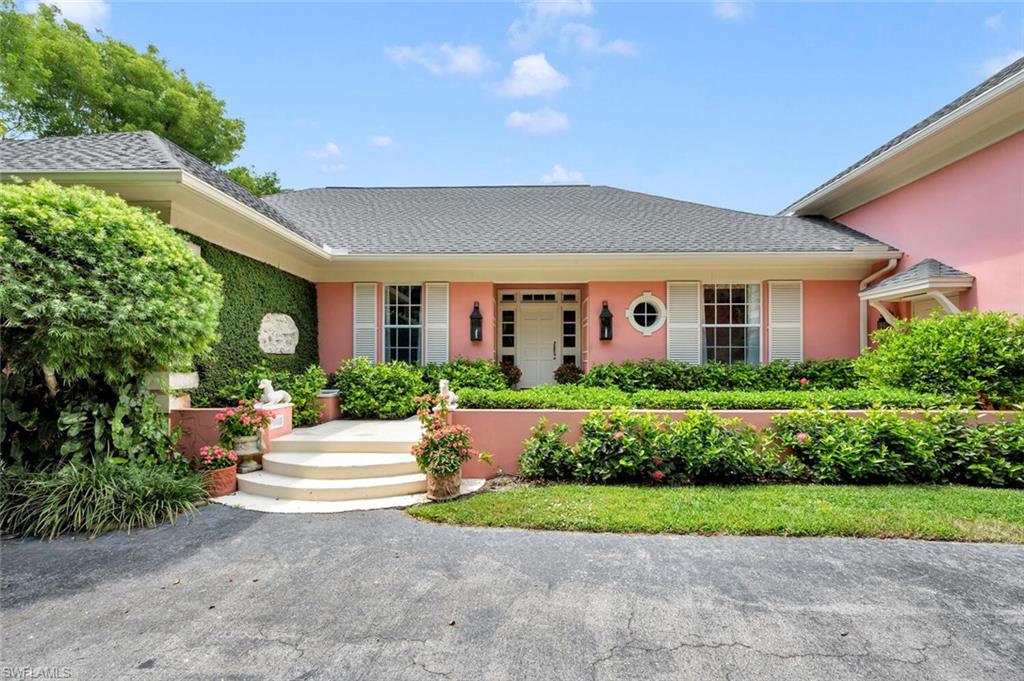 a front view of house with yard and green space