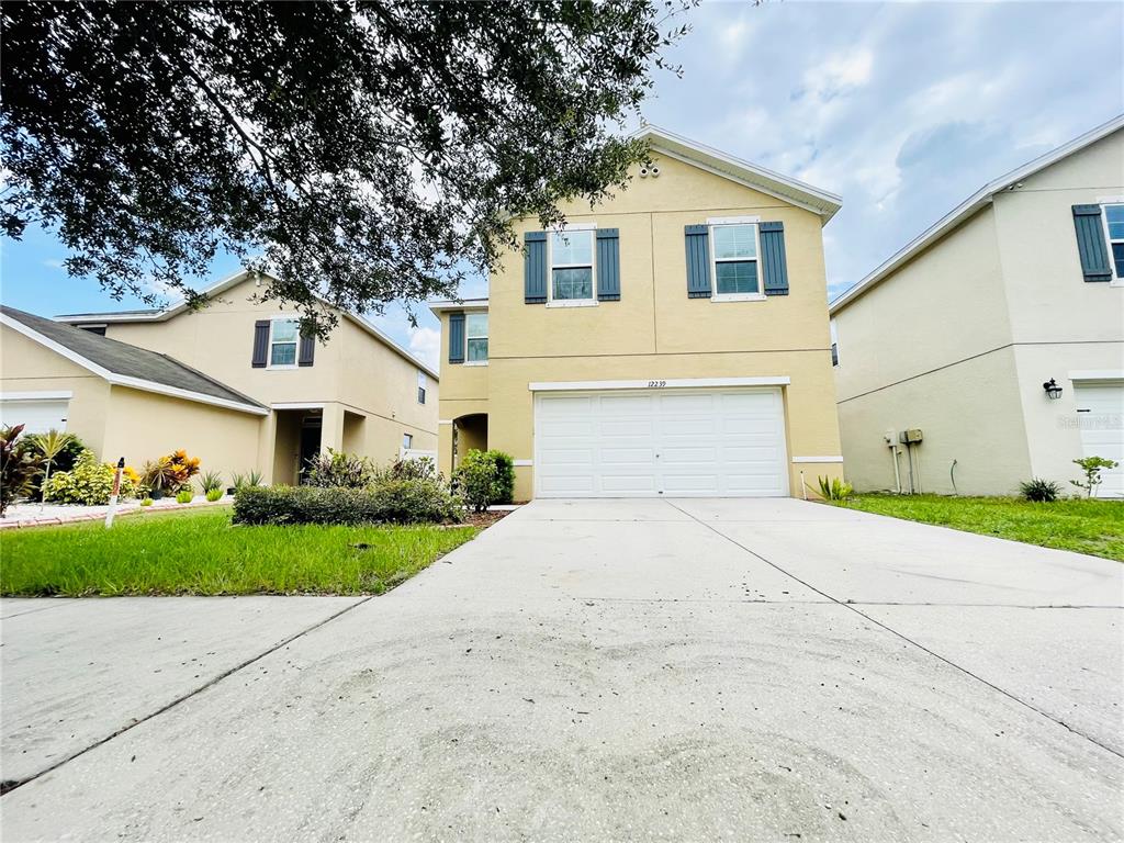 a front view of a house with a yard and garage