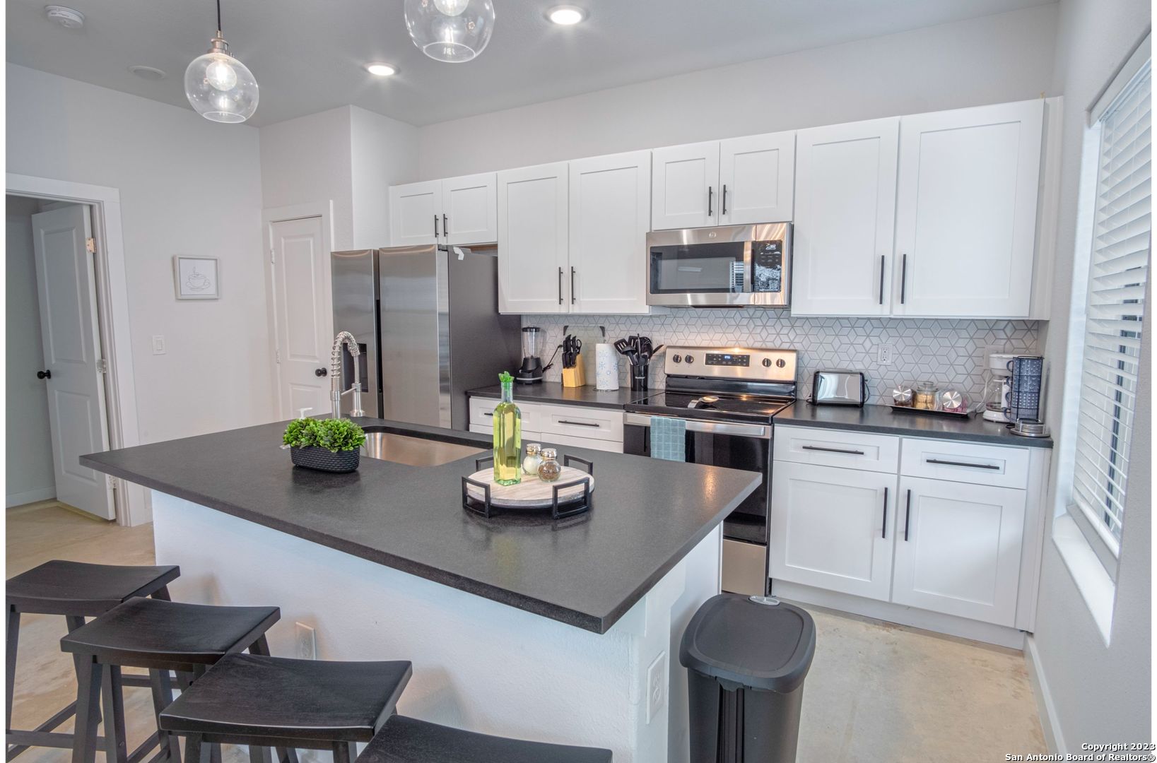 a kitchen with refrigerator and cabinets