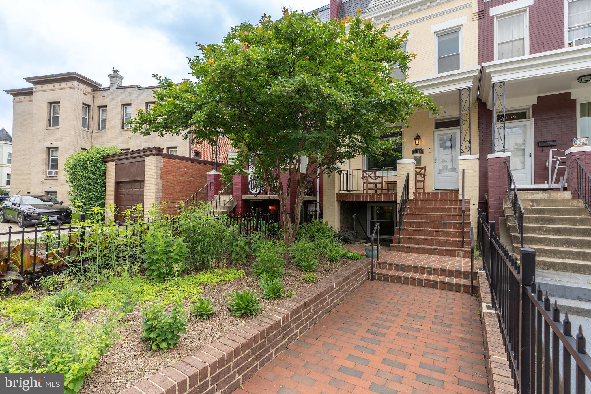 a front view of a house with a garden