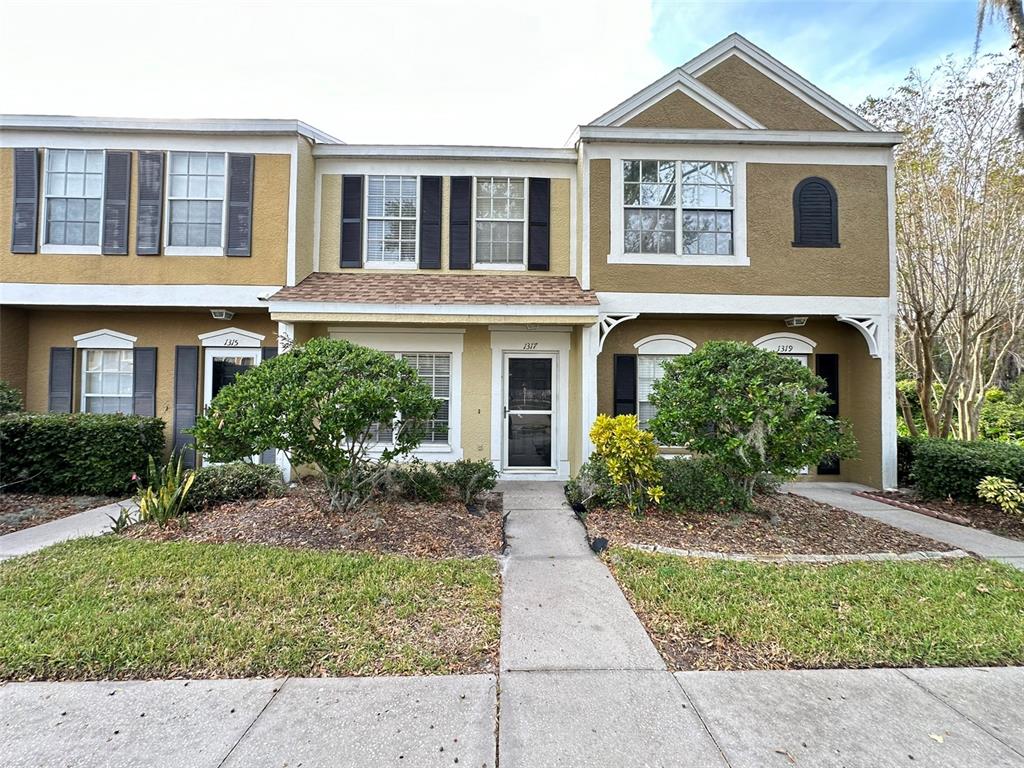 a front view of a house with garden