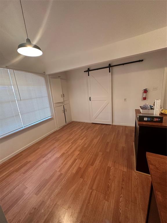 a view of a room with wooden floor