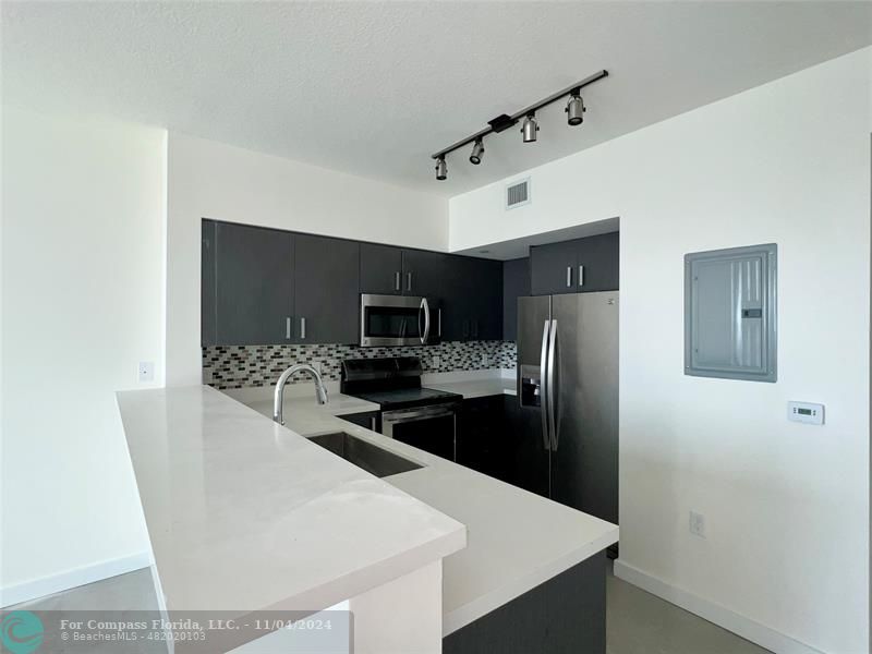 a kitchen with stainless steel appliances a refrigerator and a stove