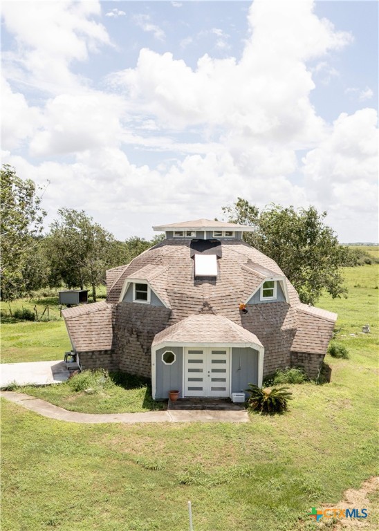 a view of a house with a yard and sitting area