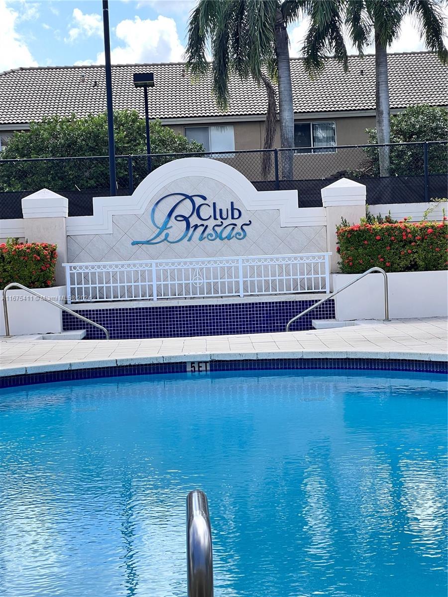 a view of a swimming pool with a yard