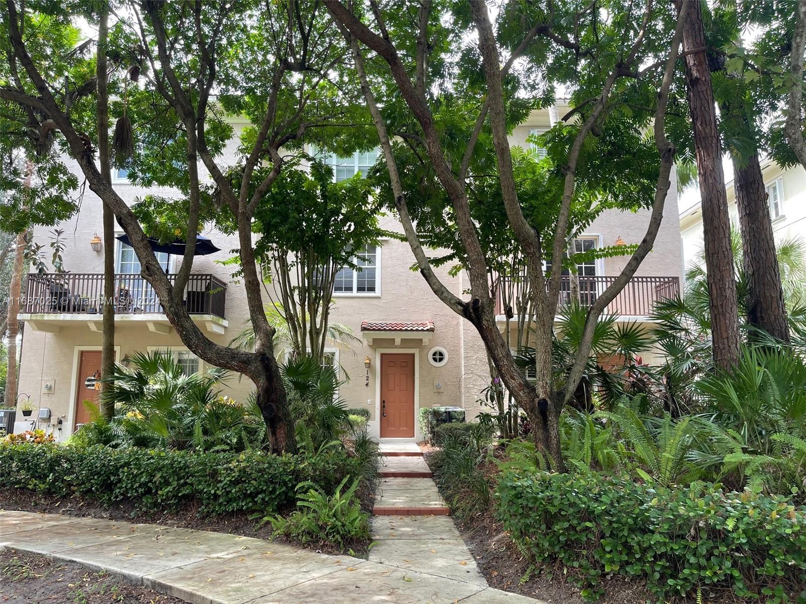 front view of a house with a tree