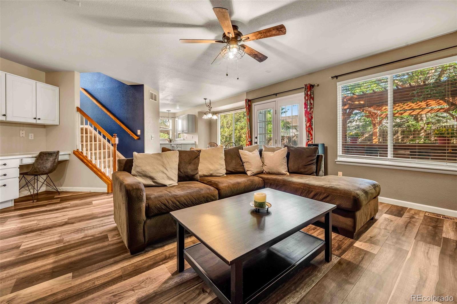 a living room with furniture a table and a large window