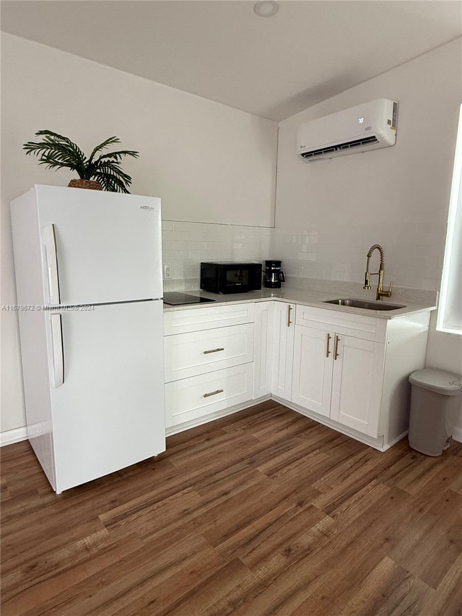 a kitchen with granite countertop a sink a stove and cabinets