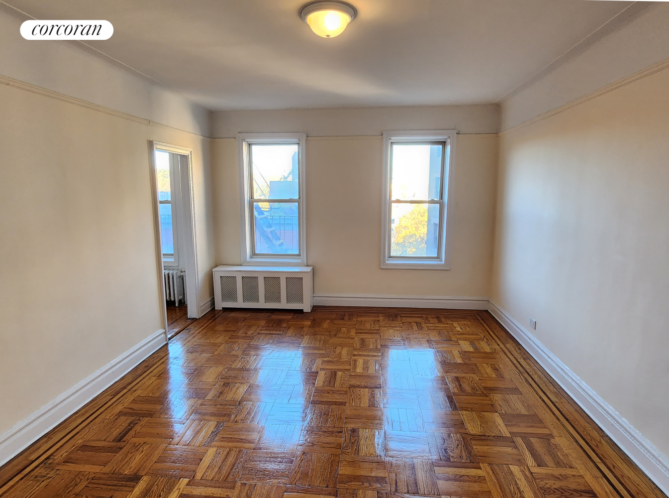 a view of a room with wooden floor and window