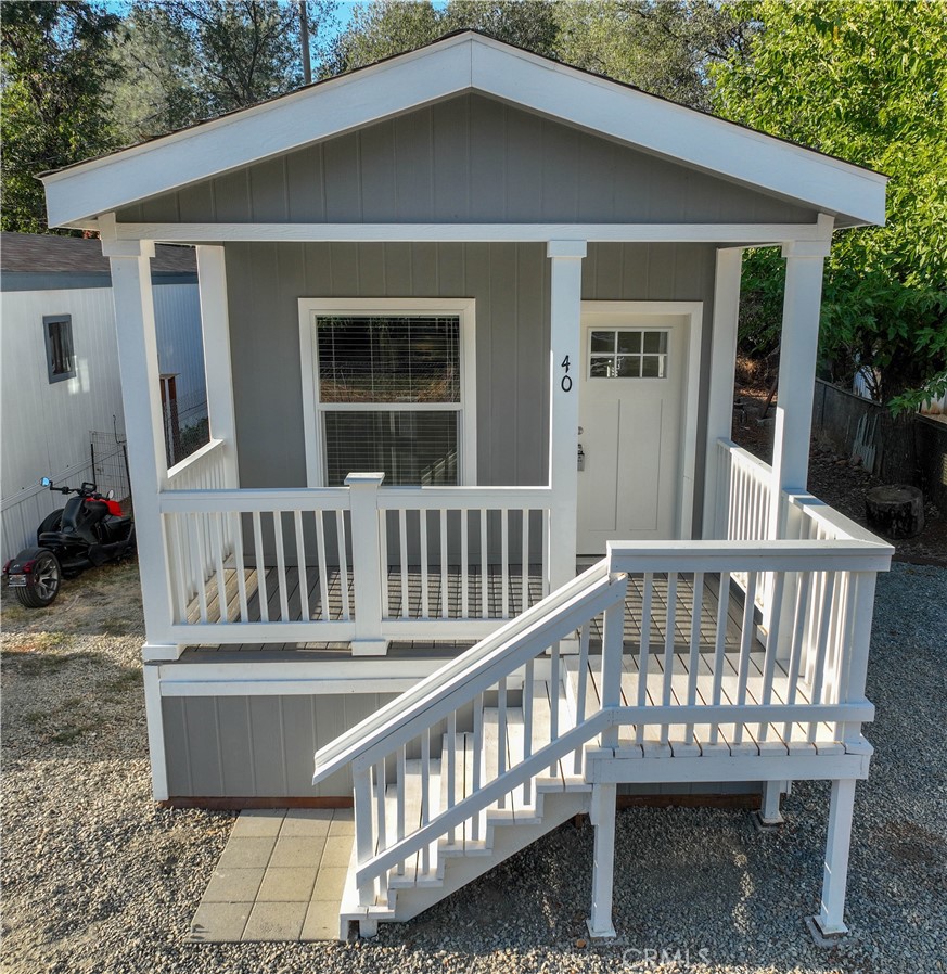 a view of a house with a wooden deck