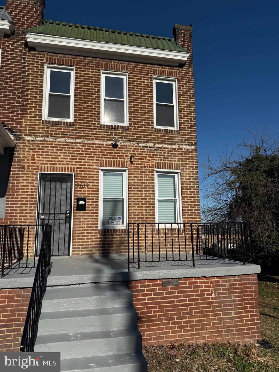 a view of a brick house with many windows