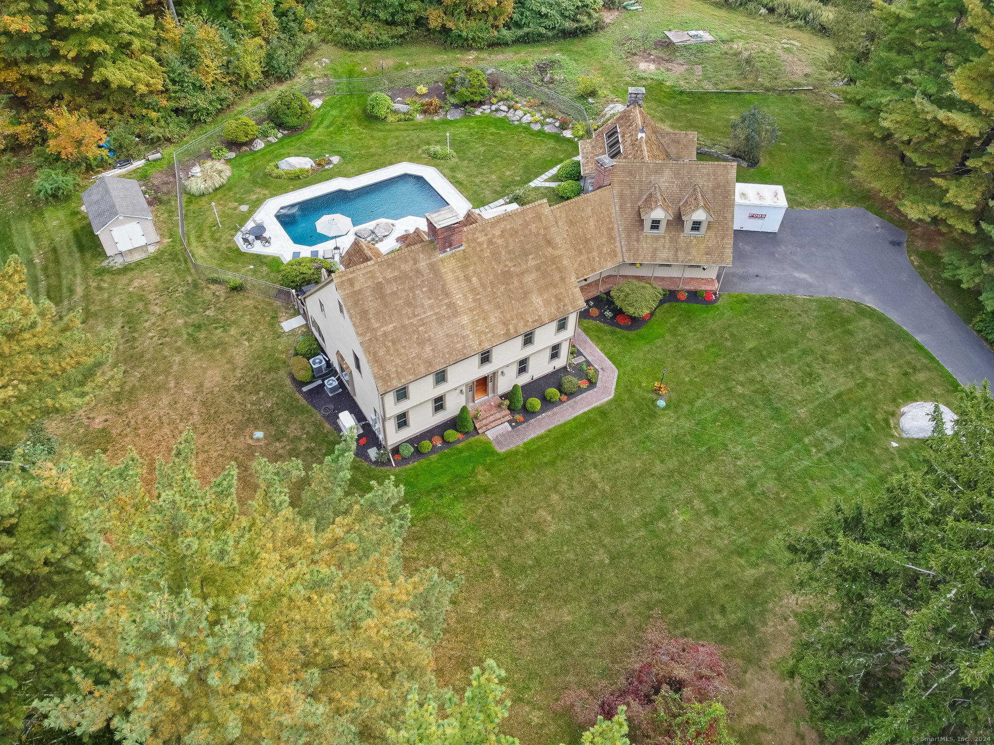 an aerial view of a house with garden space and street view