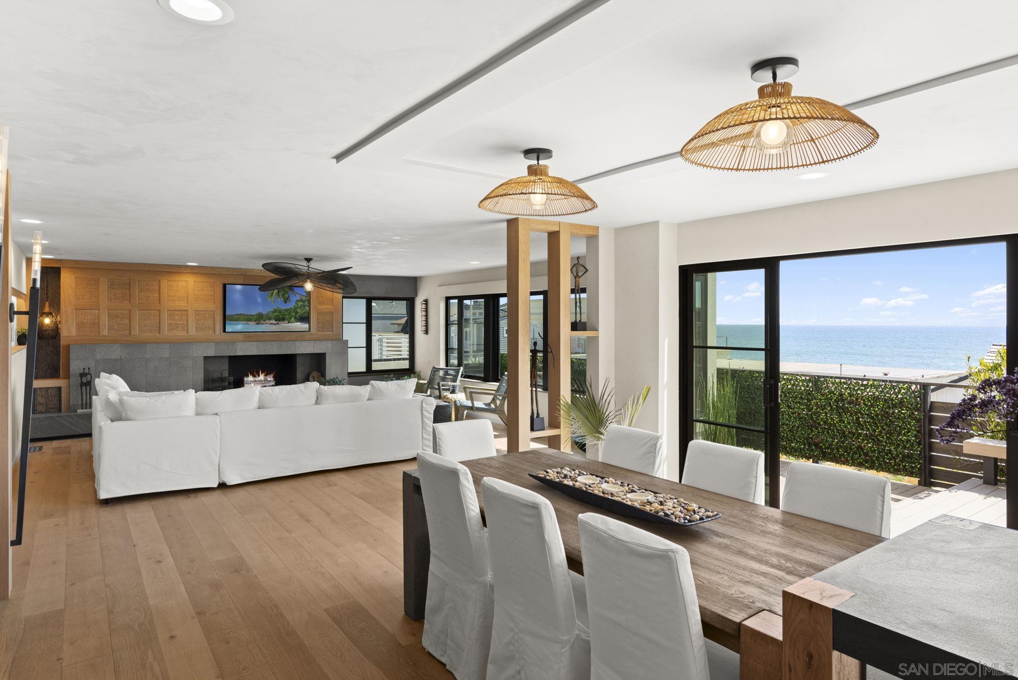 a living room with fireplace furniture and a floor to ceiling window