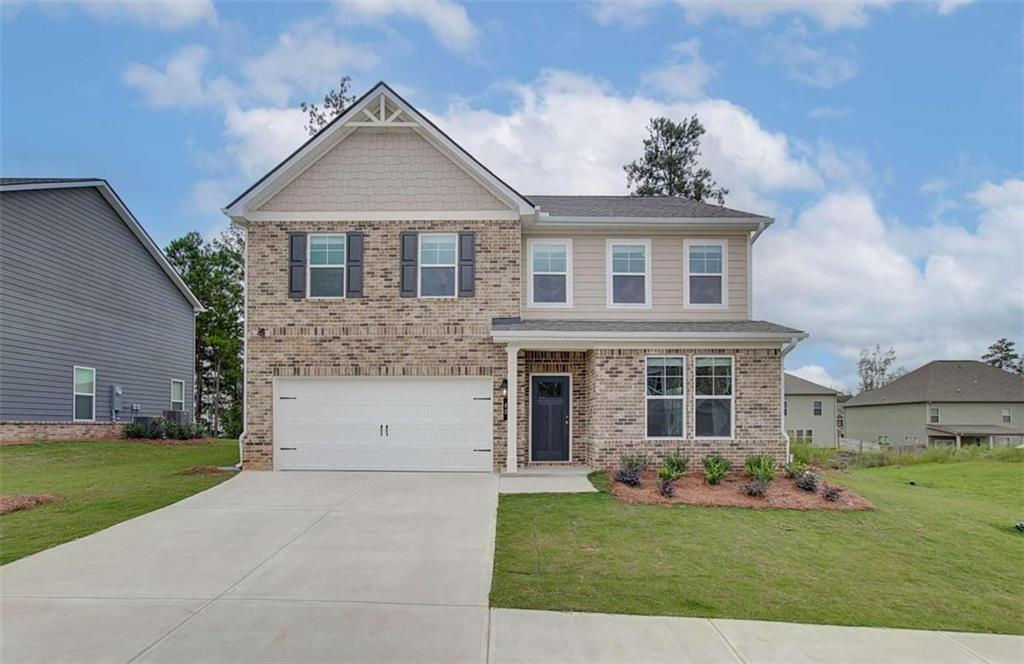 a front view of a house with a yard