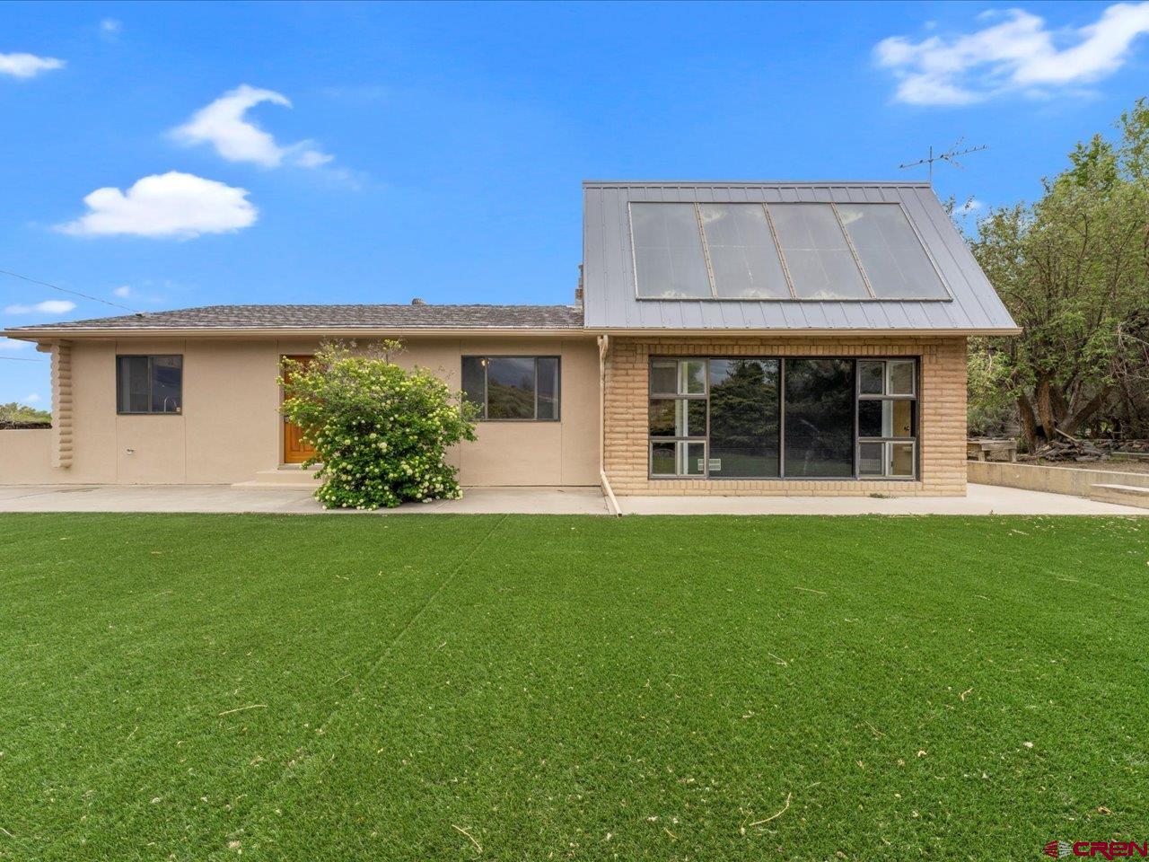 a front view of a house with a garden