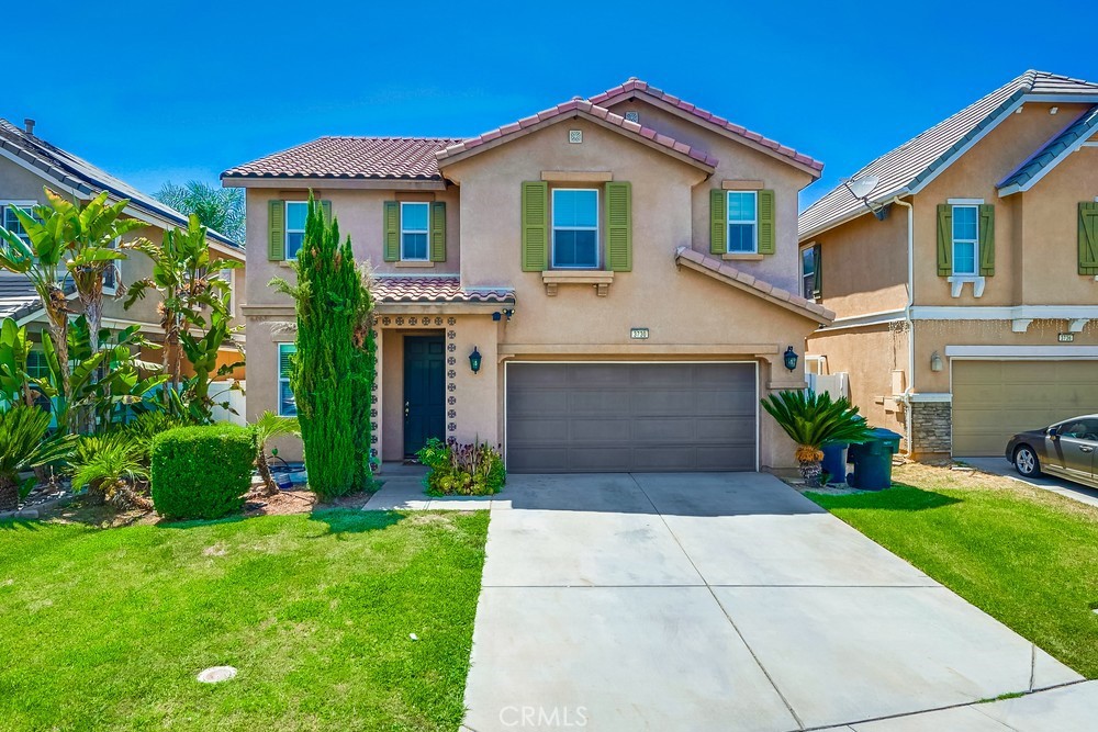 a front view of a house with a yard and garage