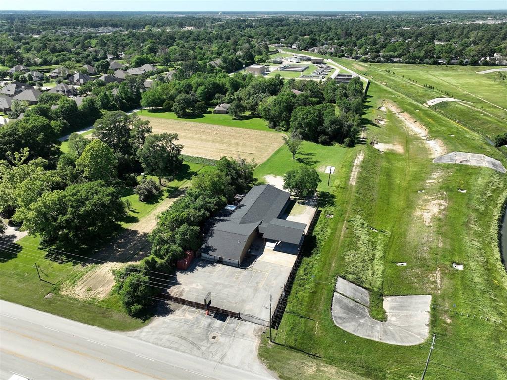 an aerial view of residential houses with outdoor space and trees