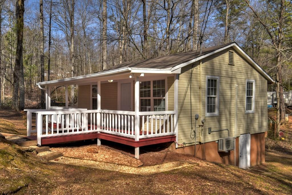 a view of a house with a yard and deck