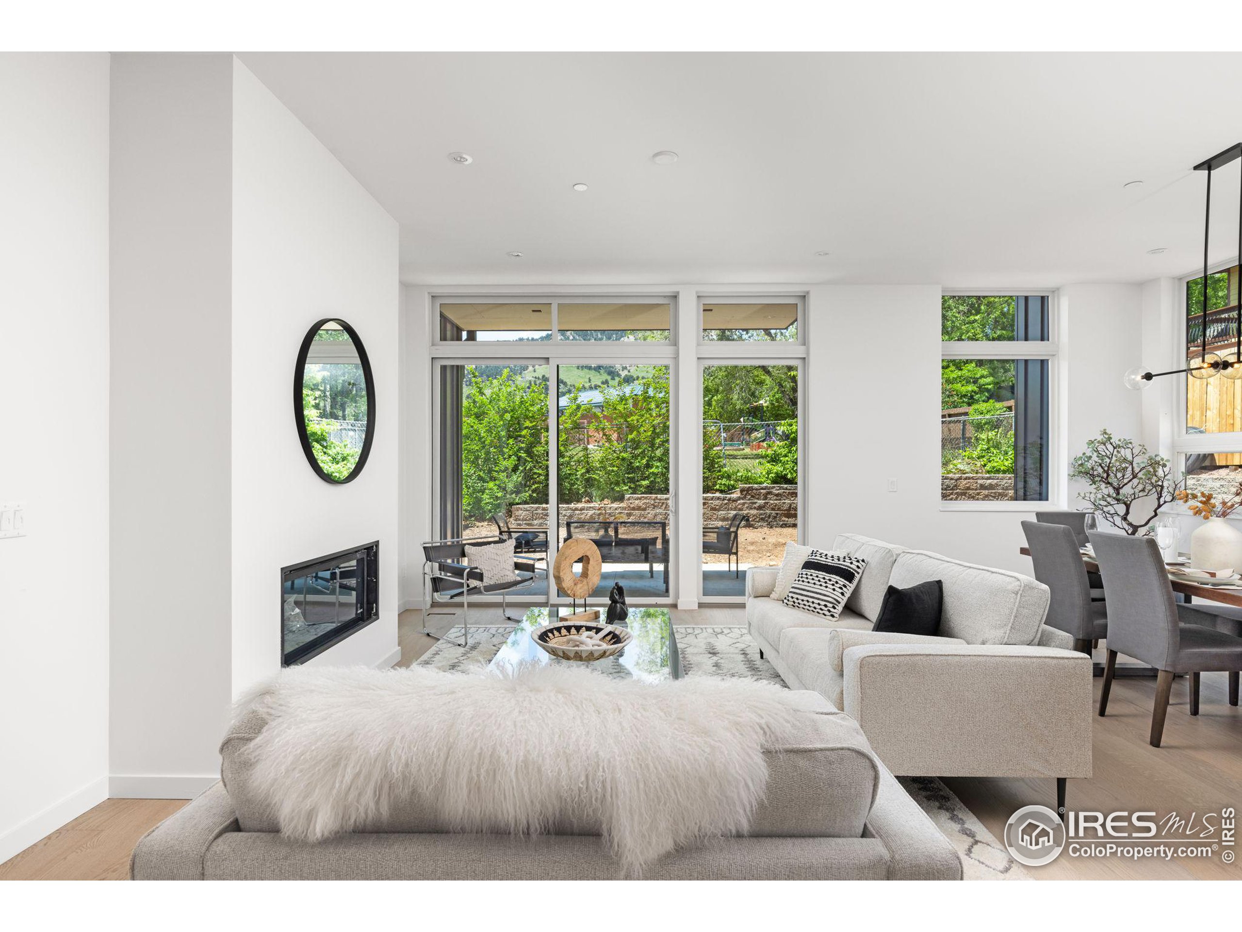 a living room with furniture a table and a large window