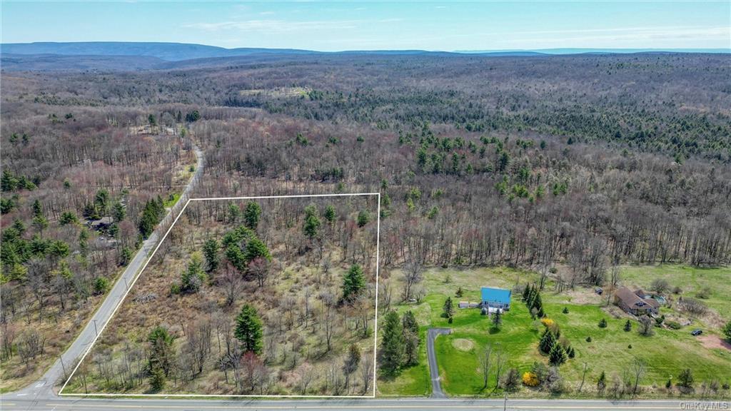 an aerial view of house with yard