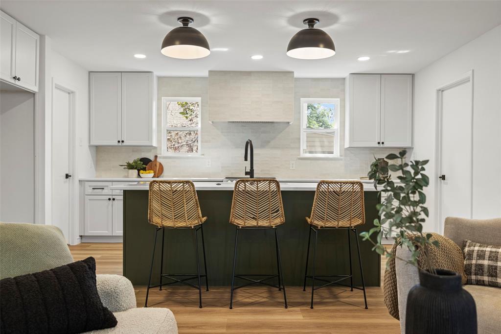 a kitchen with granite countertop a table and chairs