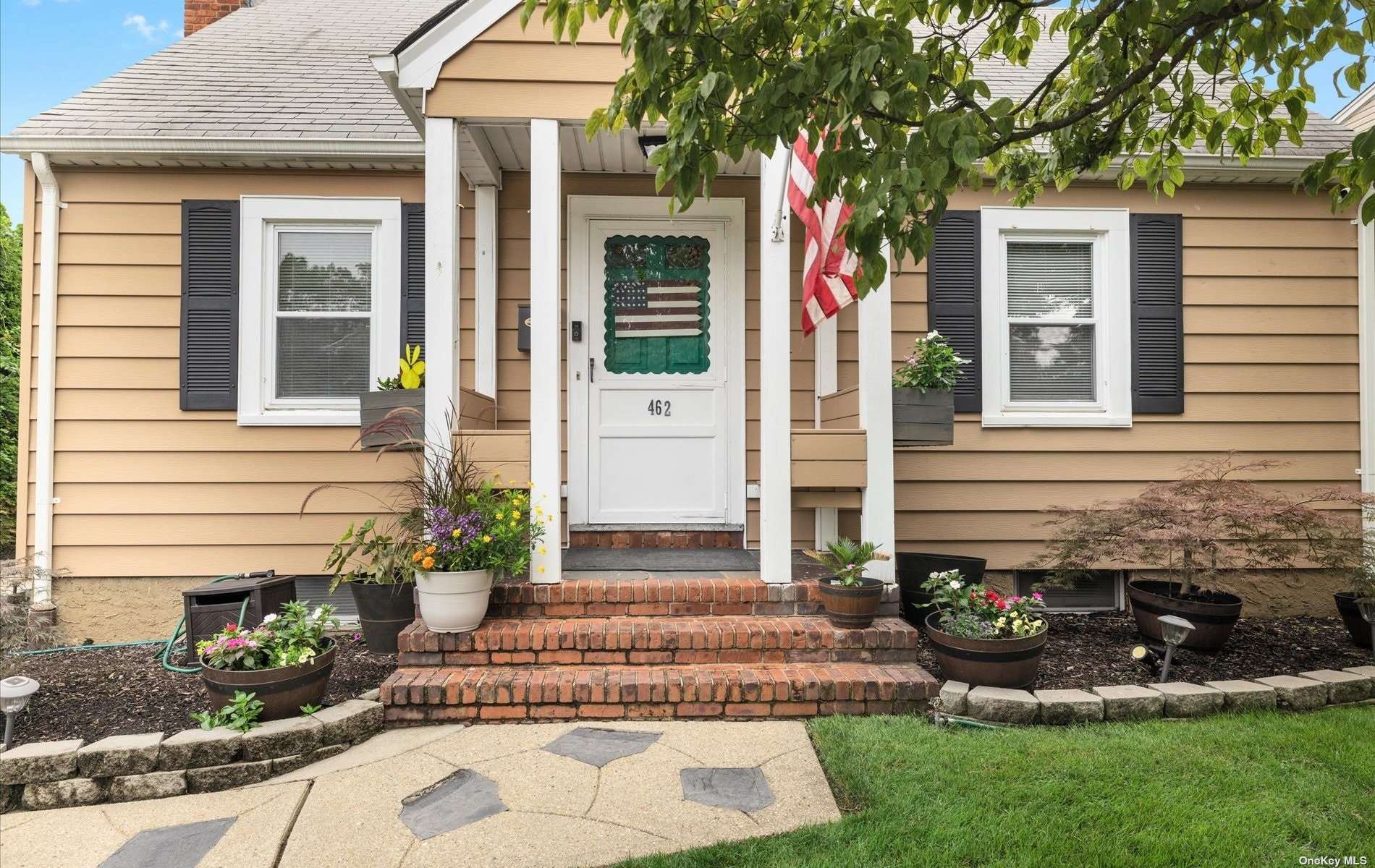 a front view of a house with garden