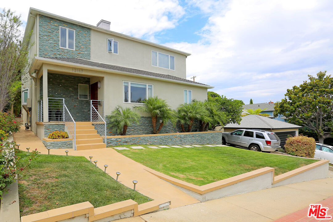 a front view of a house with garden