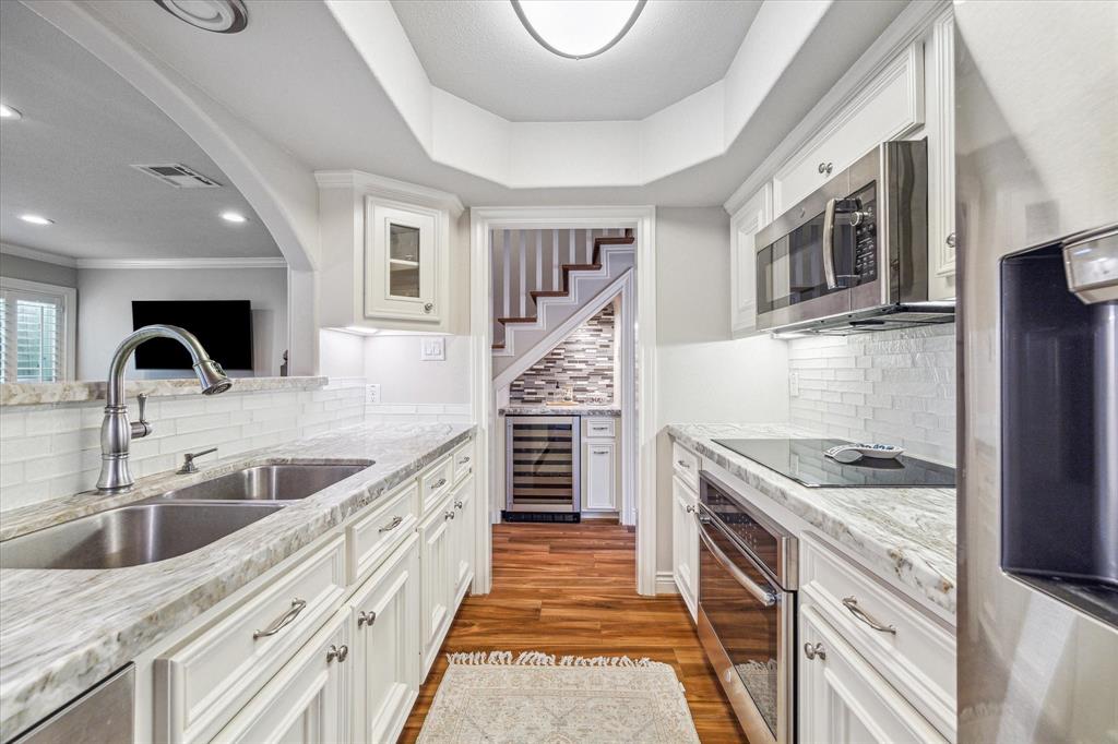 a kitchen with stainless steel appliances granite countertop a sink and stove top oven