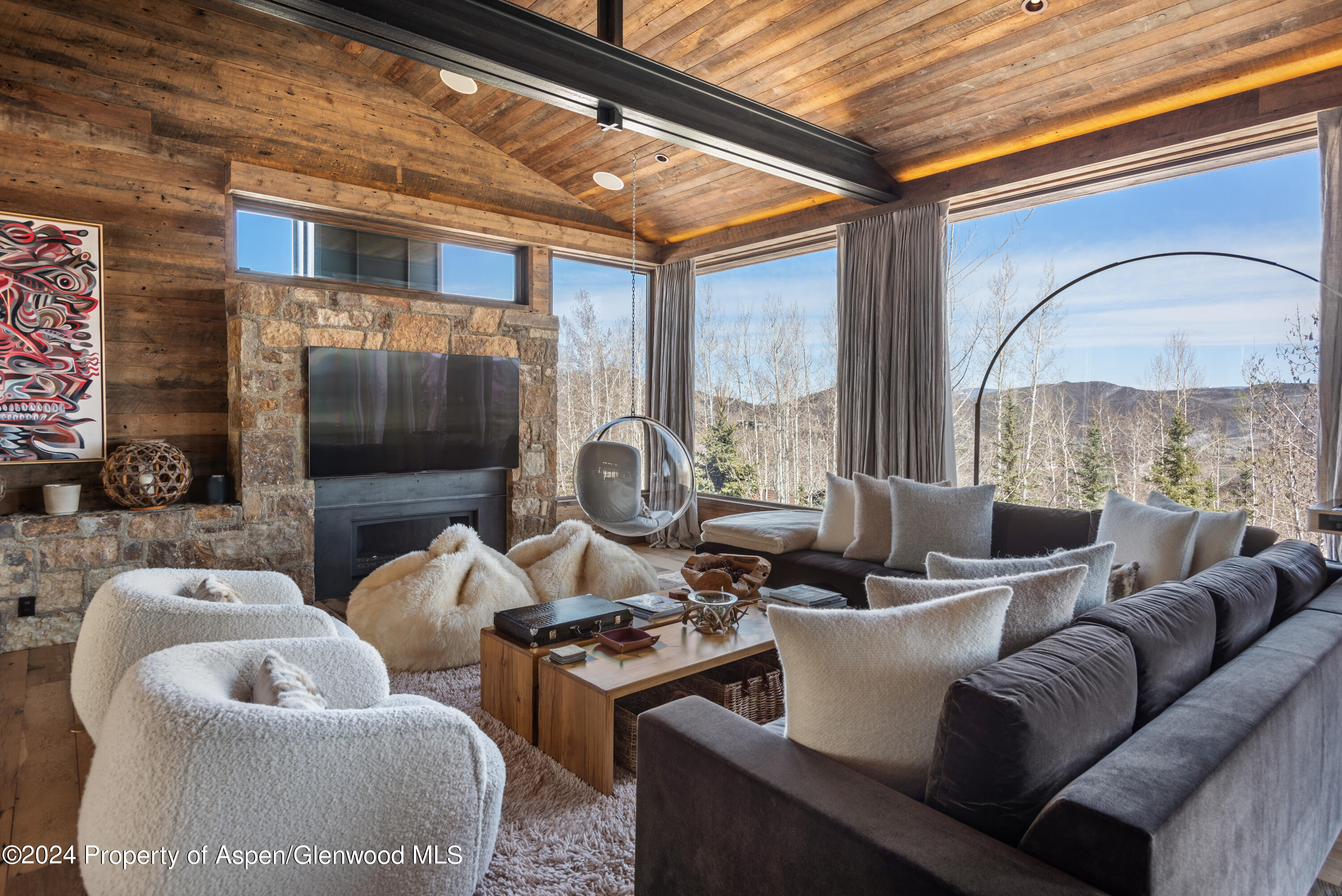 a living room with furniture a large window and a flat screen tv