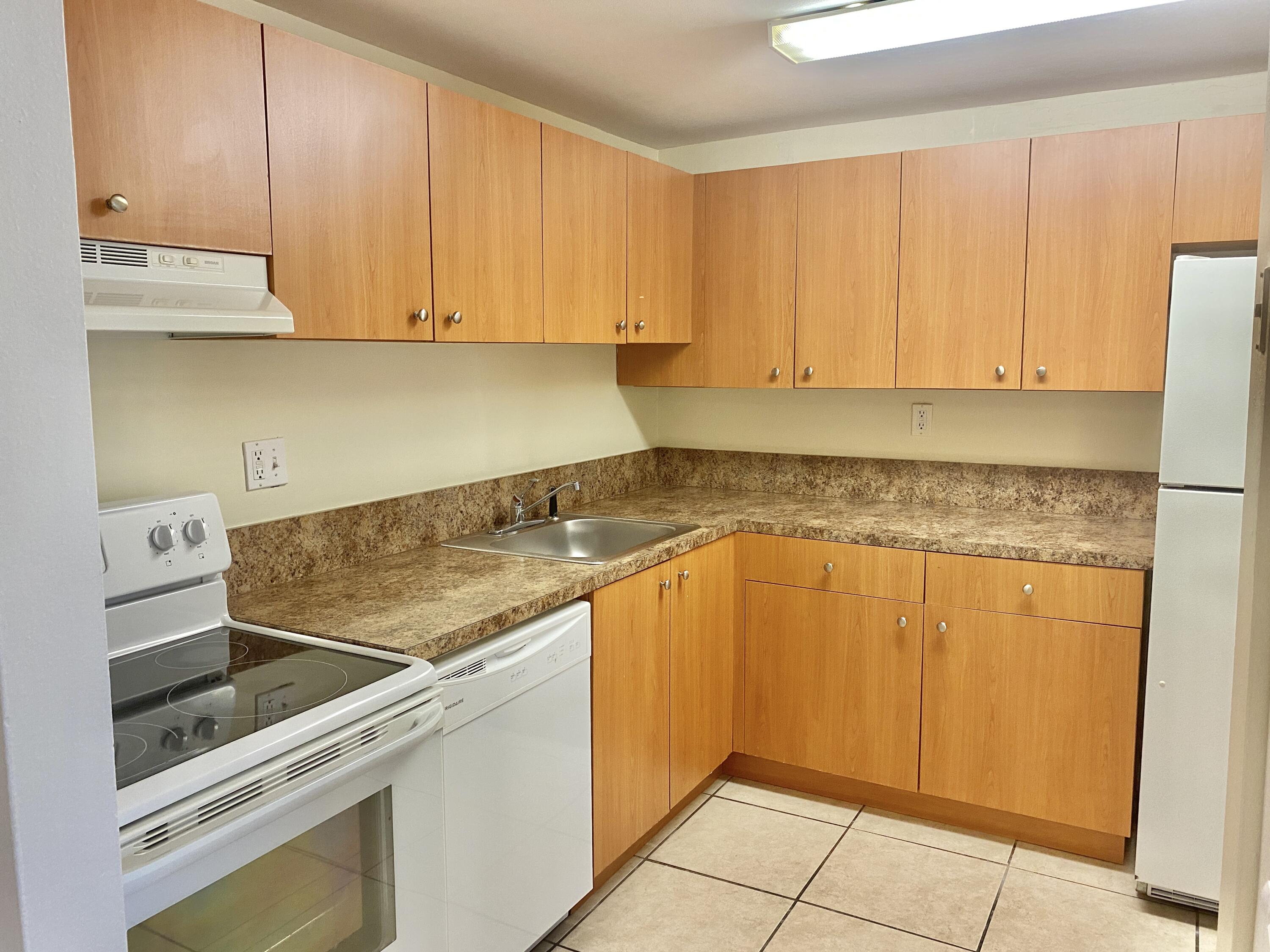 a kitchen with granite countertop a sink and cabinets