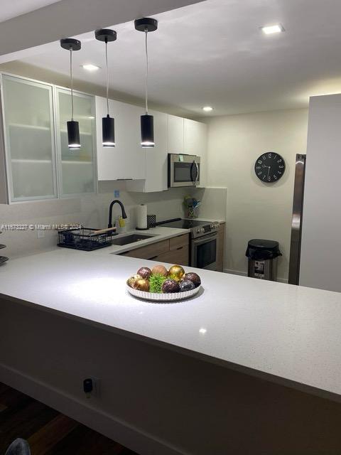 a kitchen with stainless steel appliances a sink stove and refrigerator