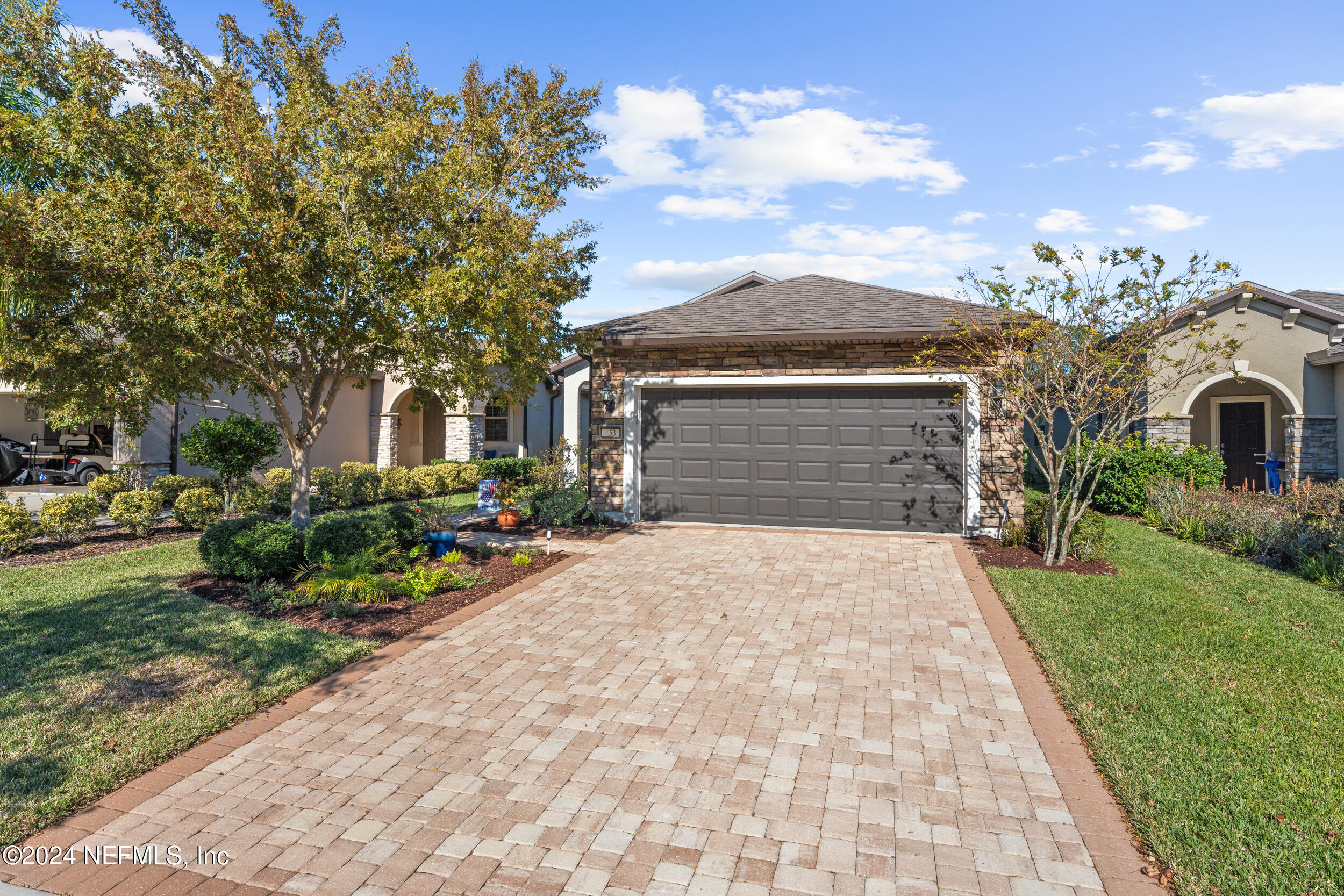 a front view of a house with garden