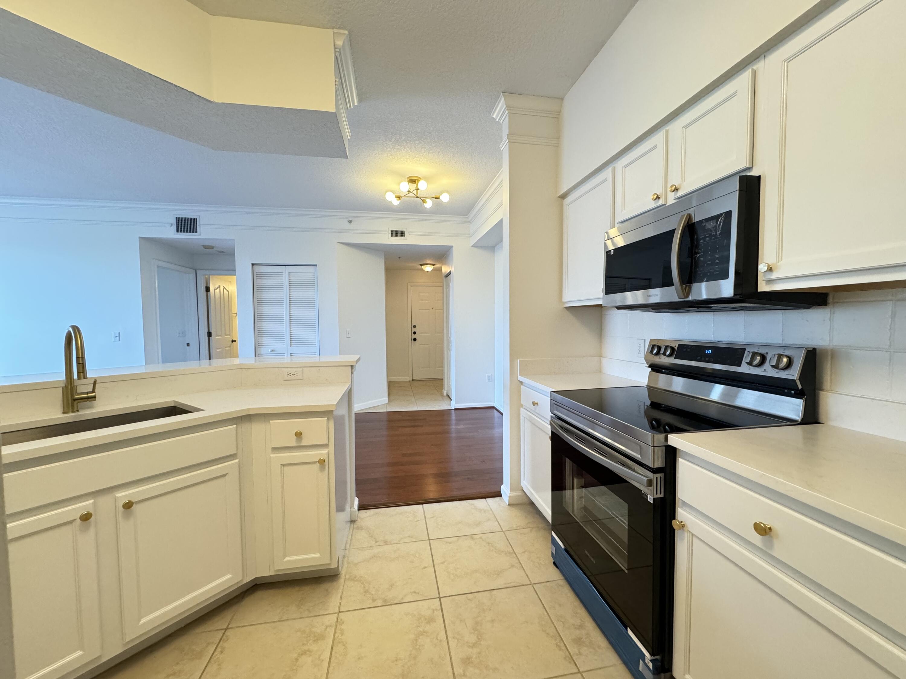 a kitchen with a sink and stainless steel appliances