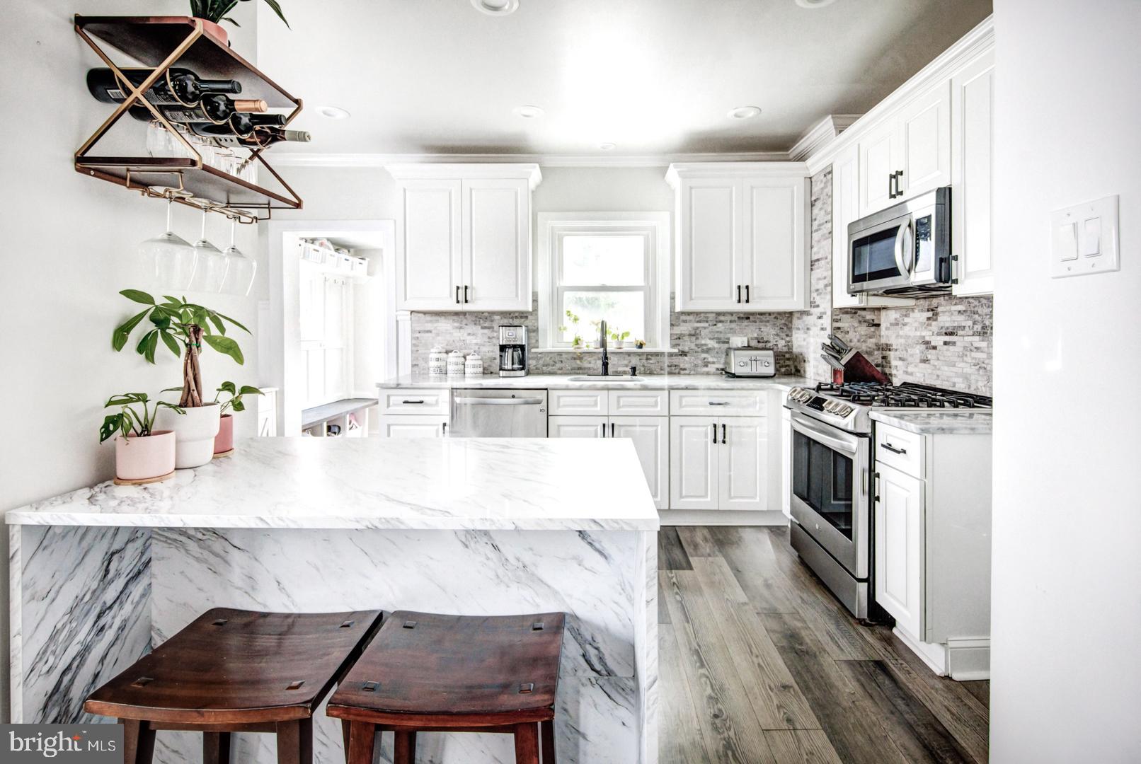 a kitchen with a table chairs microwave and cabinets