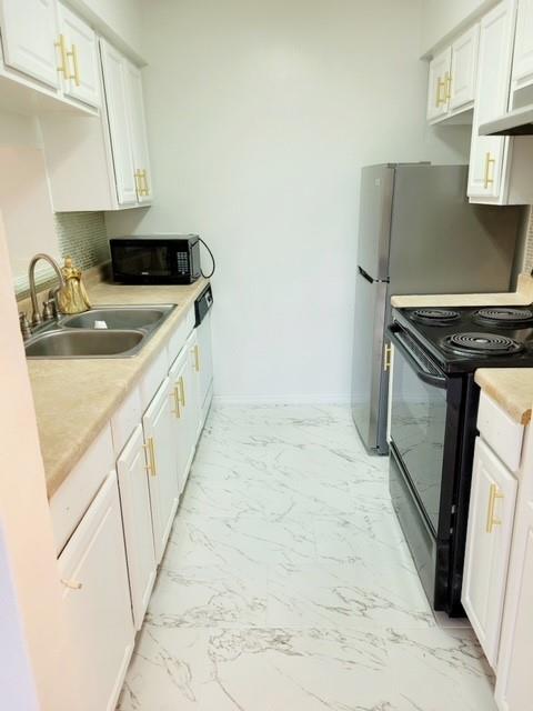 a kitchen with a sink stove and cabinets