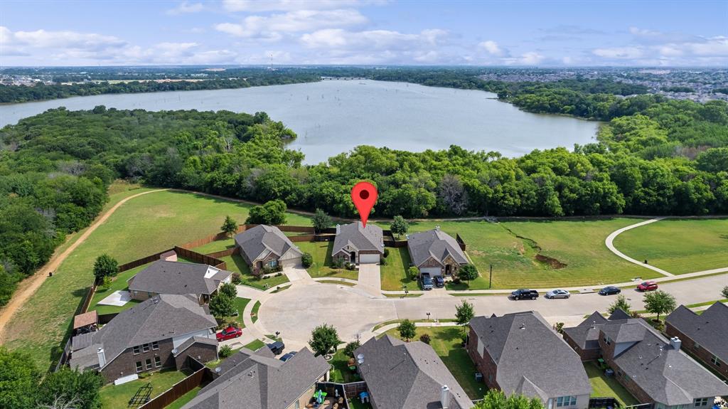 an aerial view of a house with outdoor space and lake view