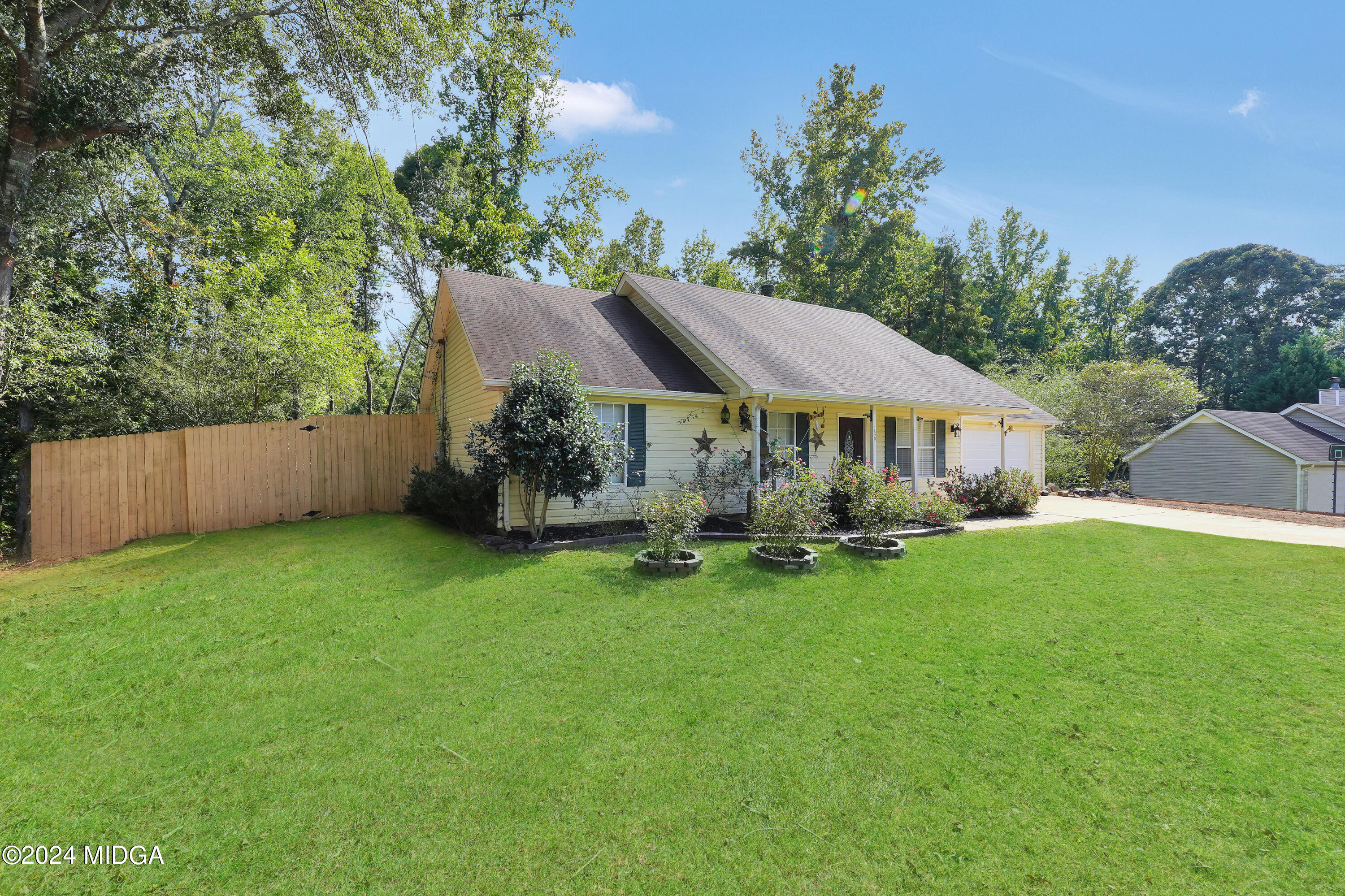 a view of house with backyard and outdoor seating