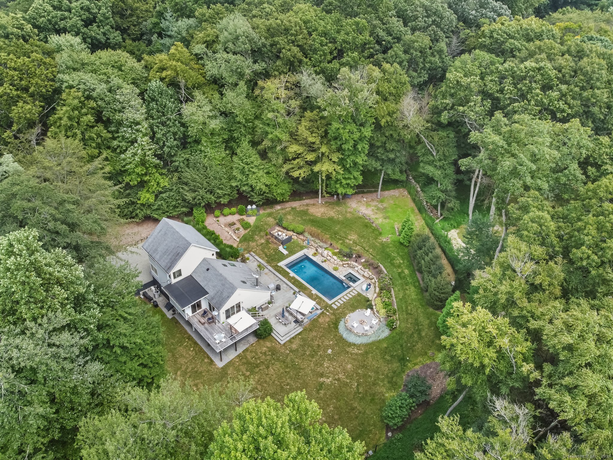 an aerial view of a house with a yard