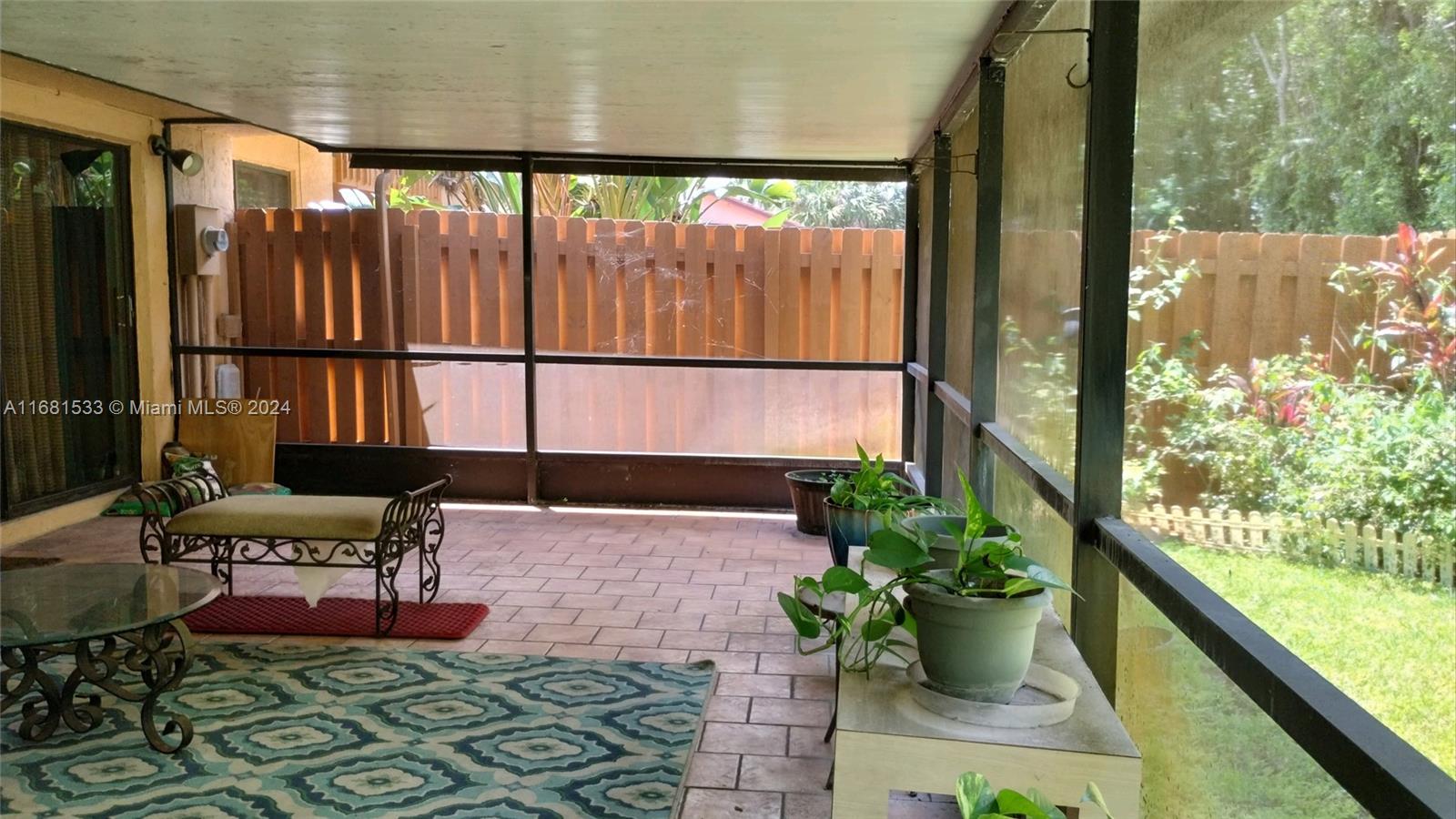 a building outdoor space with patio furniture and potted plants