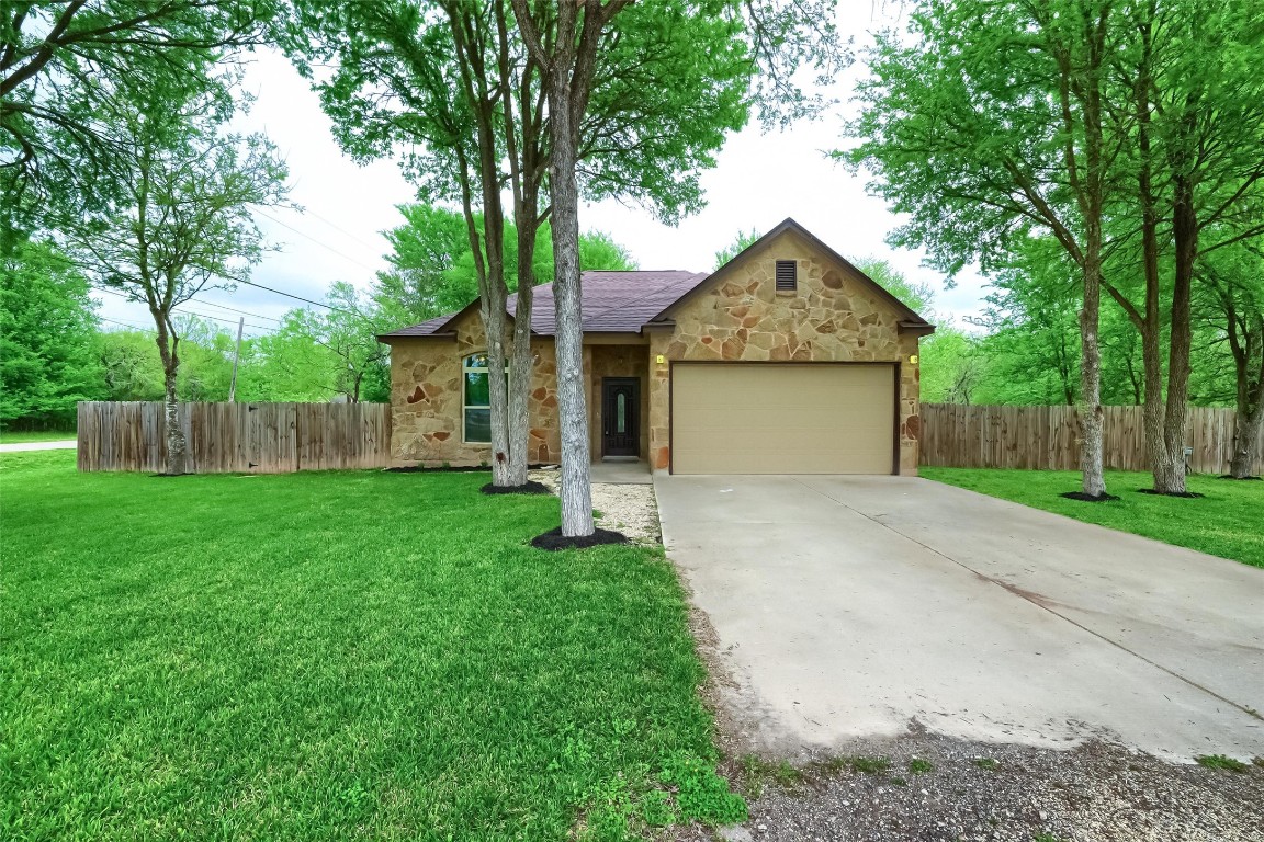 a front view of house with yard and green space