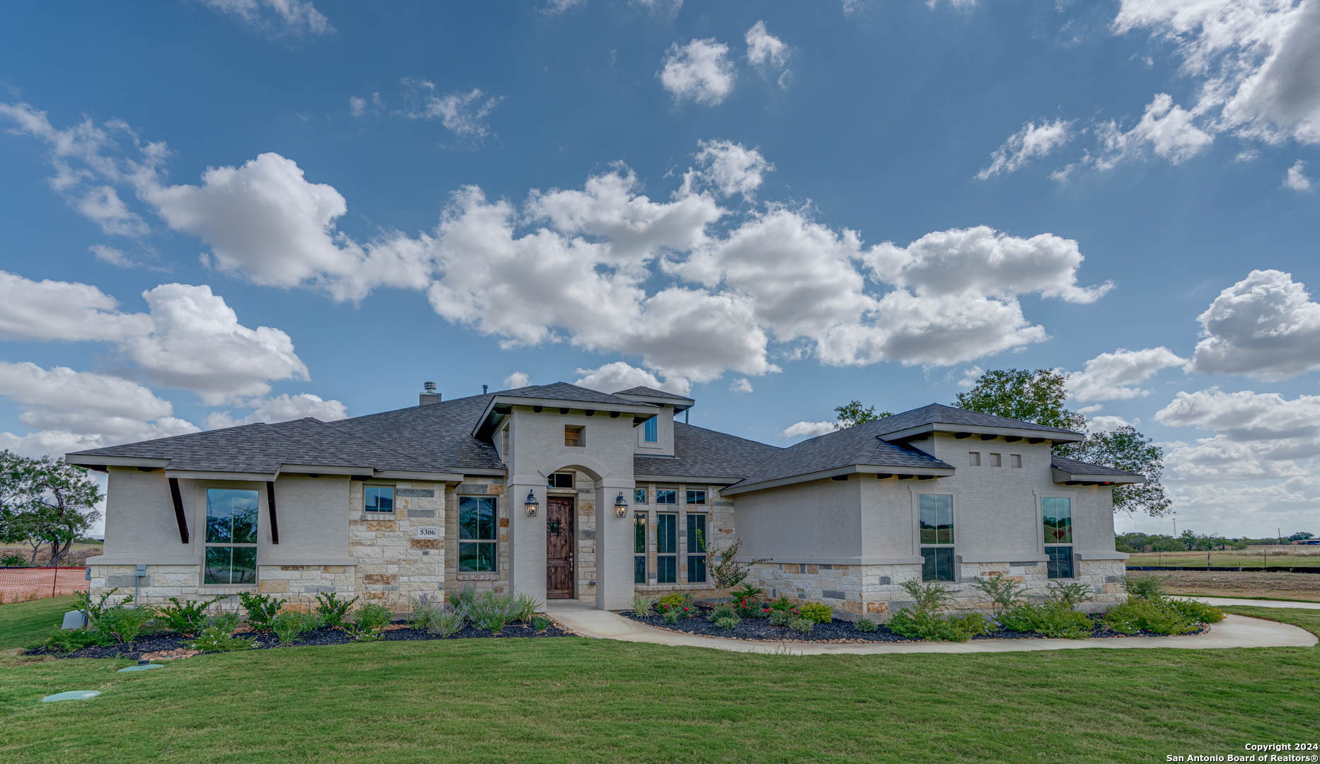 a front view of a house with garden